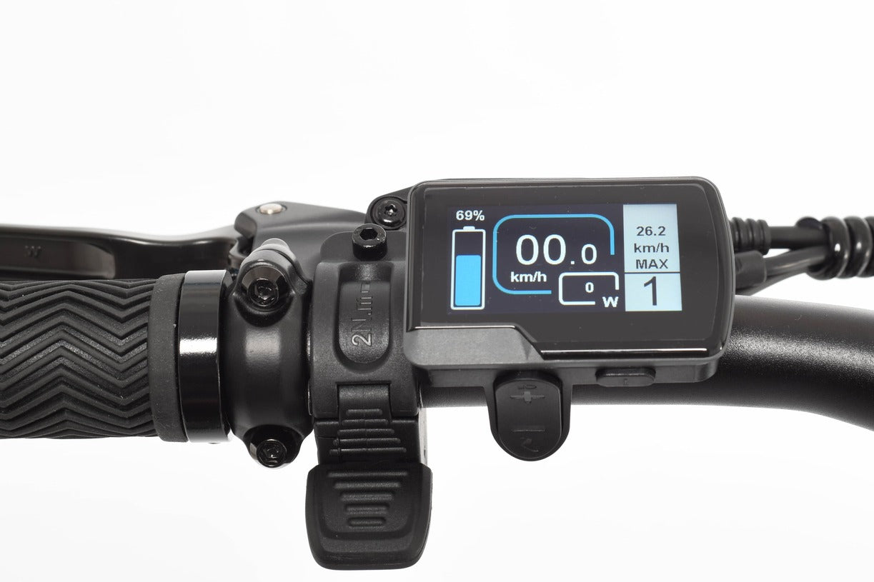 Digital display on a electric bike handlebar with battery and speed information.