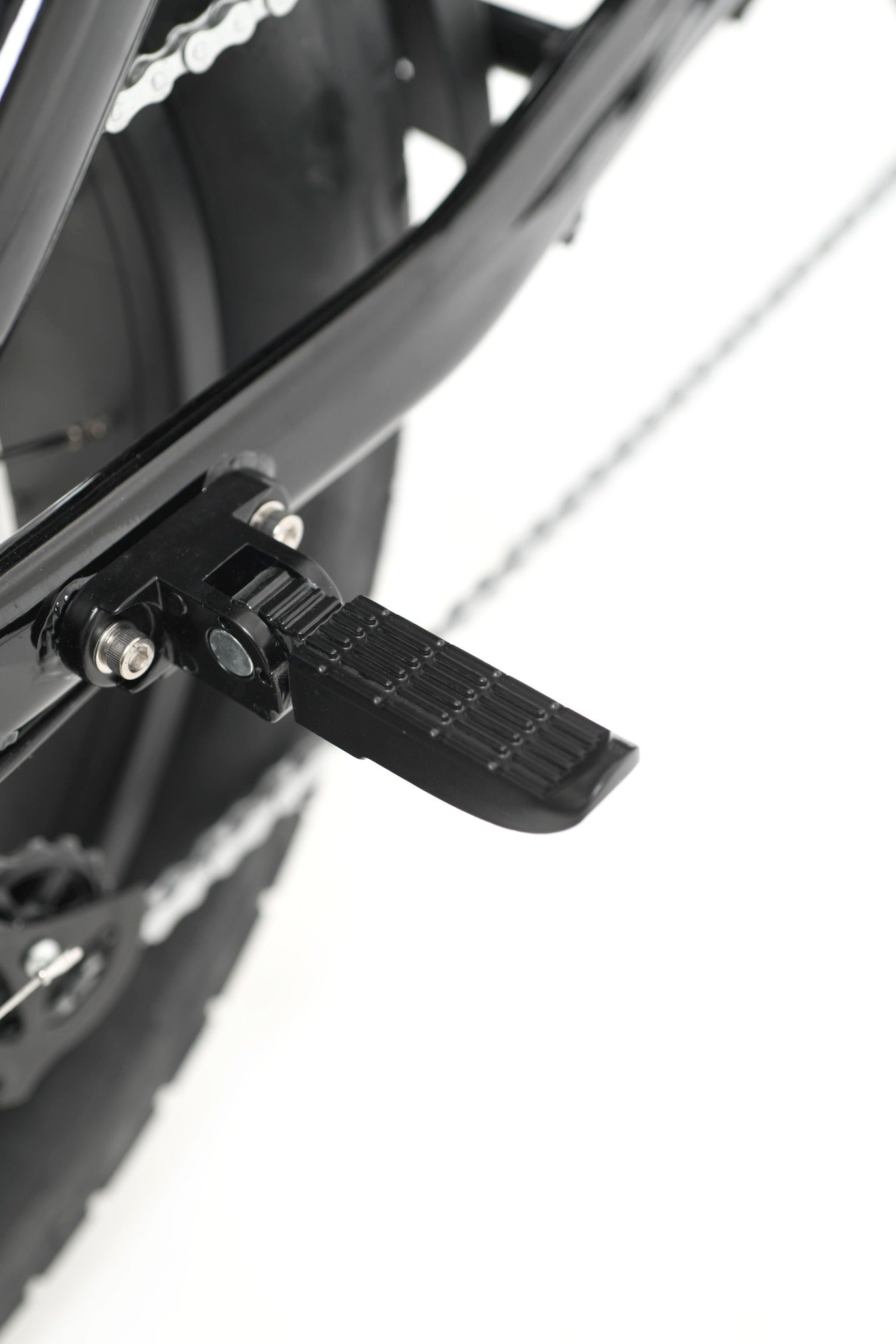 Close-up of a bicycle pedal and chain mechanism on a white background