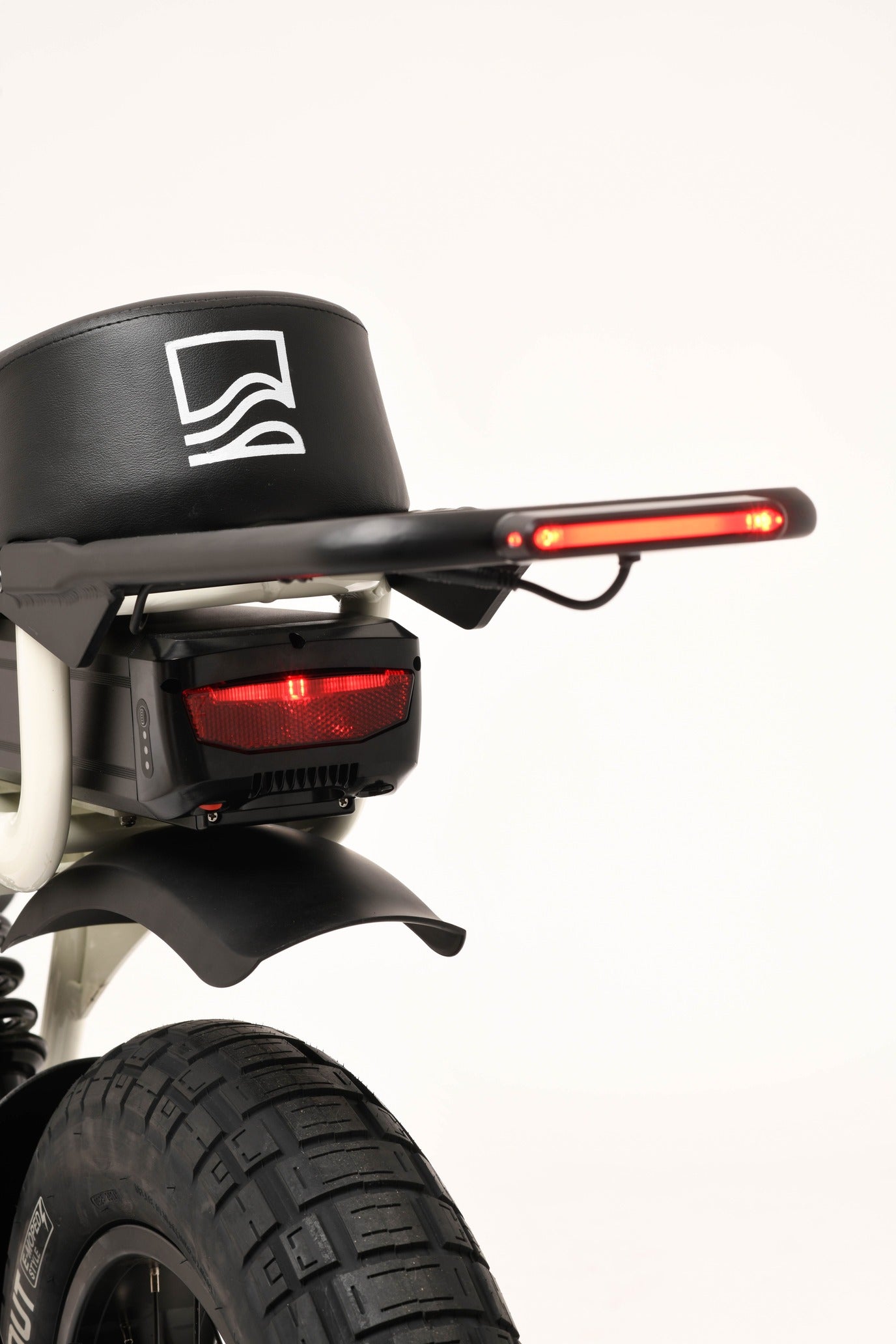 Close-up of a ebike's rear light and fender on a white background