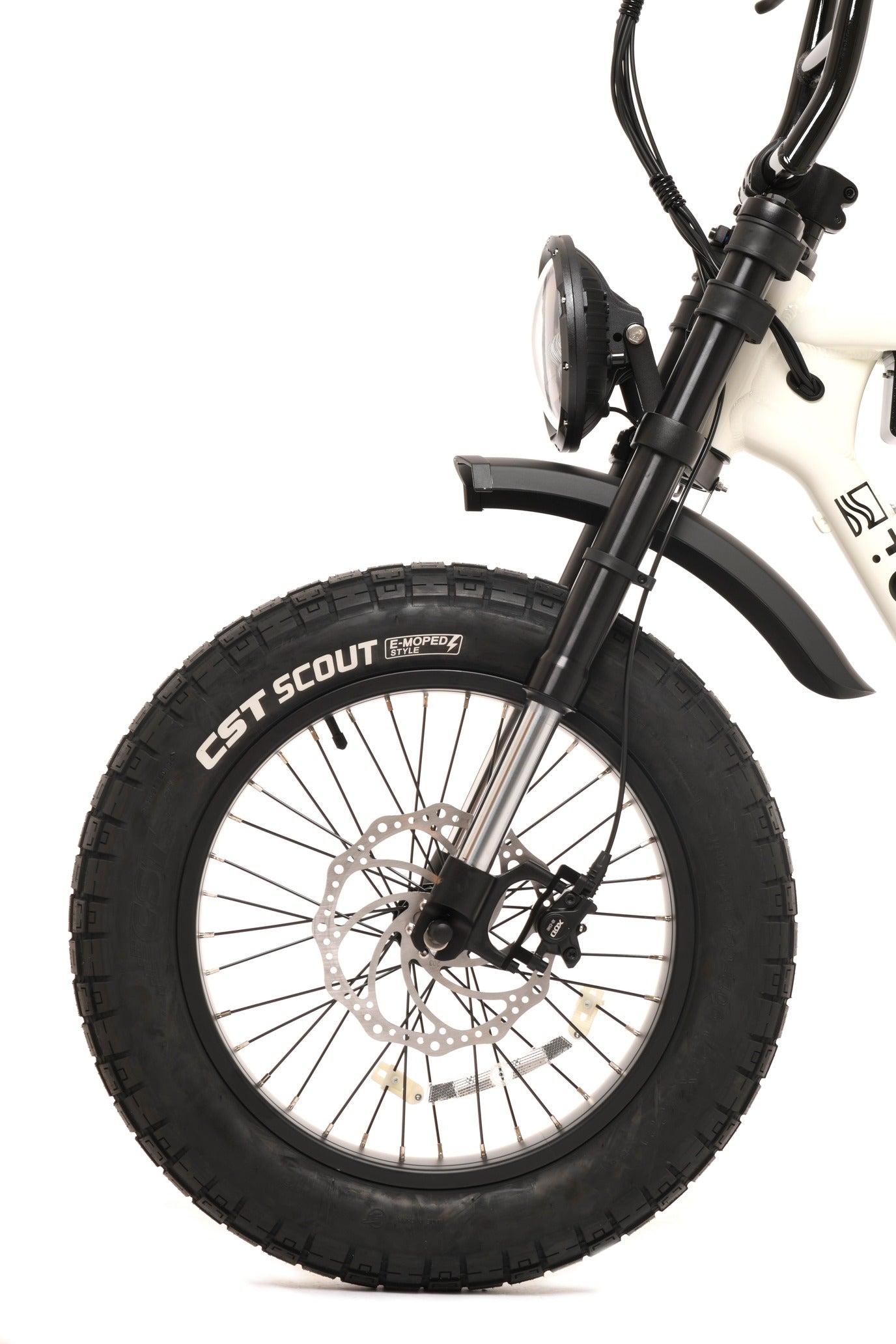 Close-up of a electric bicycle wheel with CST Scout tire on a white background