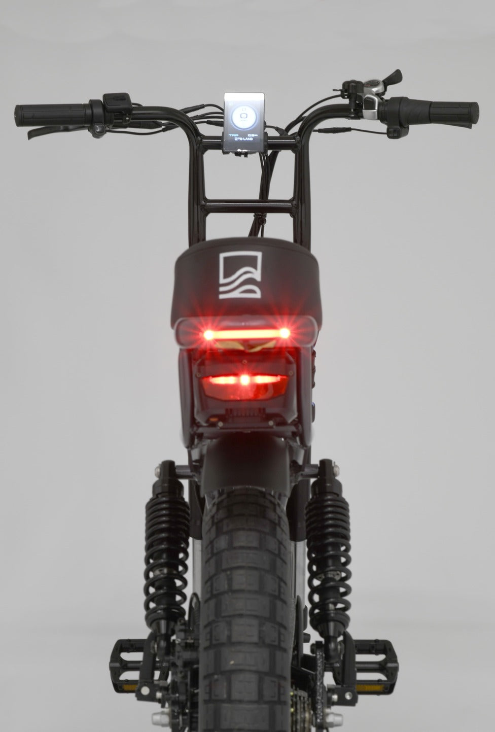 Close-up of a electric bike's rear light and design on a gray background