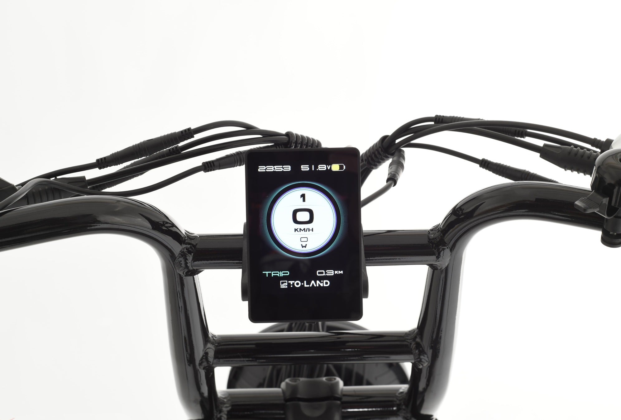 Small electronic device on a black handlebar with wires, against a white background